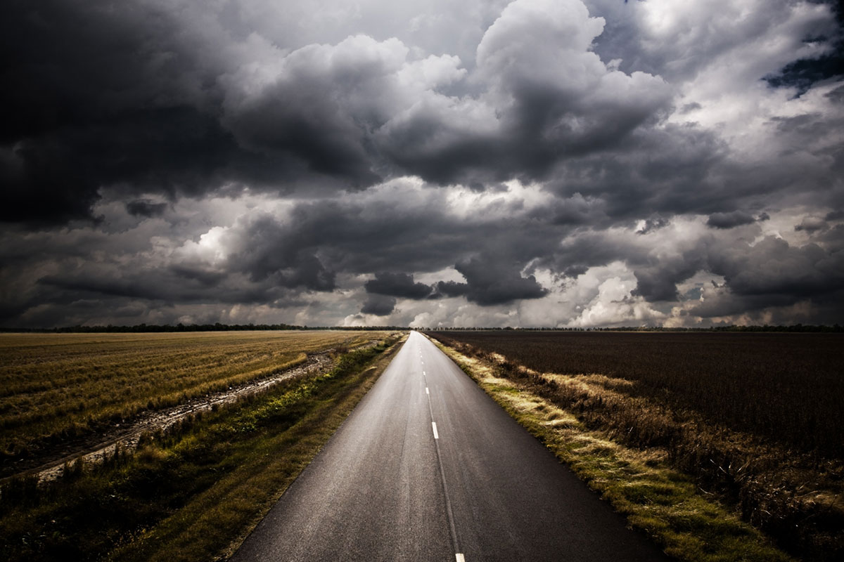 dark clouds and a one lane road, disaster ready employee benefits and you | Corporate Synergies