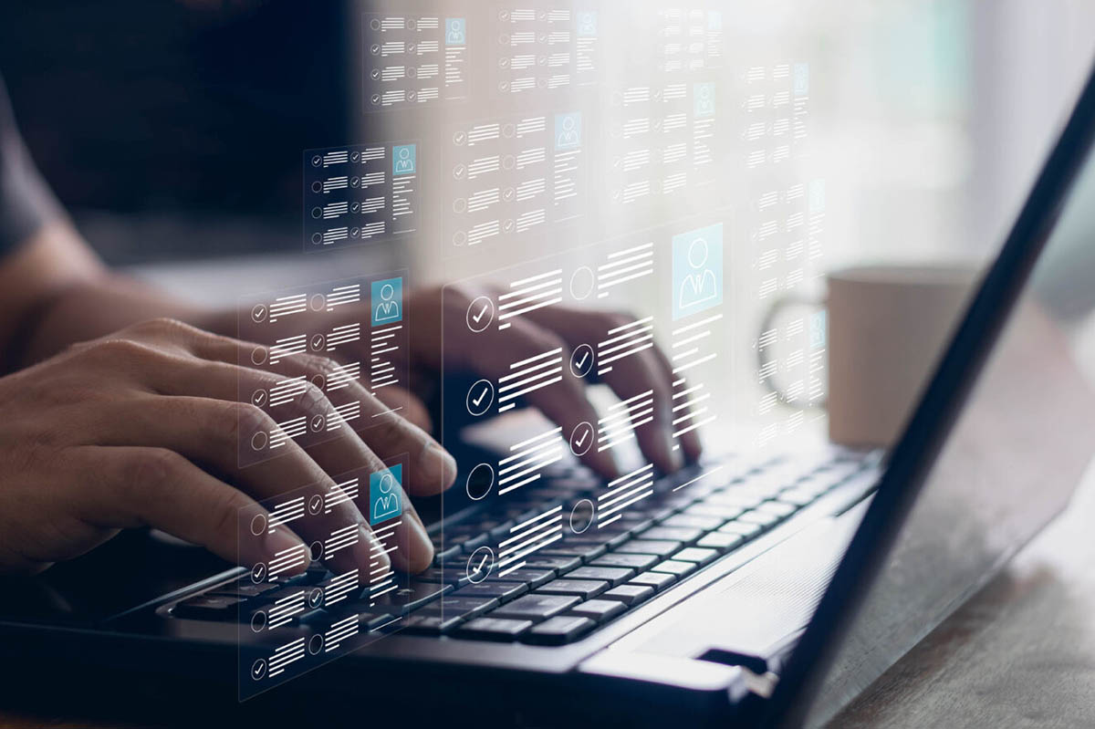 a man working on benefits technology onboarding with data hovering over the laptop keyboard| Corporate Synergies