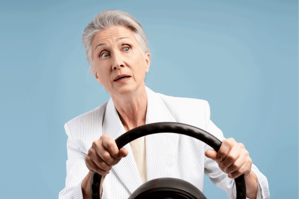 Businesswoman holding steering wheel looking worried about GLP-1 future | Corporate Synergies