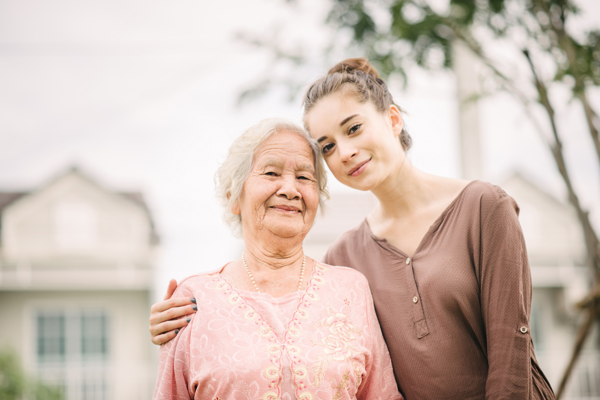 A young woman hugs her elderly relative demonstrating the care crisis in America | Corporate Synergies