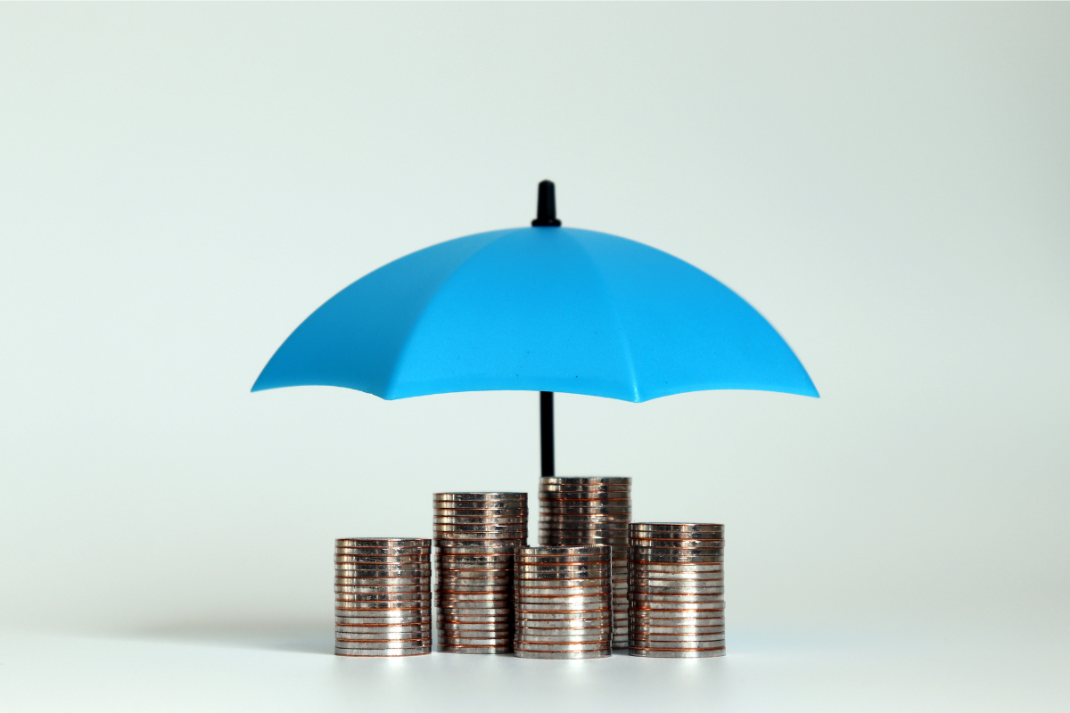 Coin stacks under an umbrella illustrate how pooling levels help manage risk for employers| Corporate Synergies